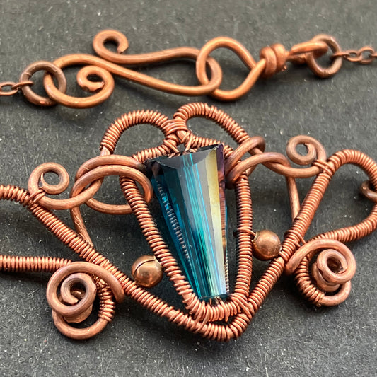 copper blue glass necklace with copper chain and a fantasy-style design