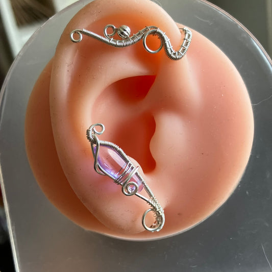 Silver ear cuff on a mannequin ear