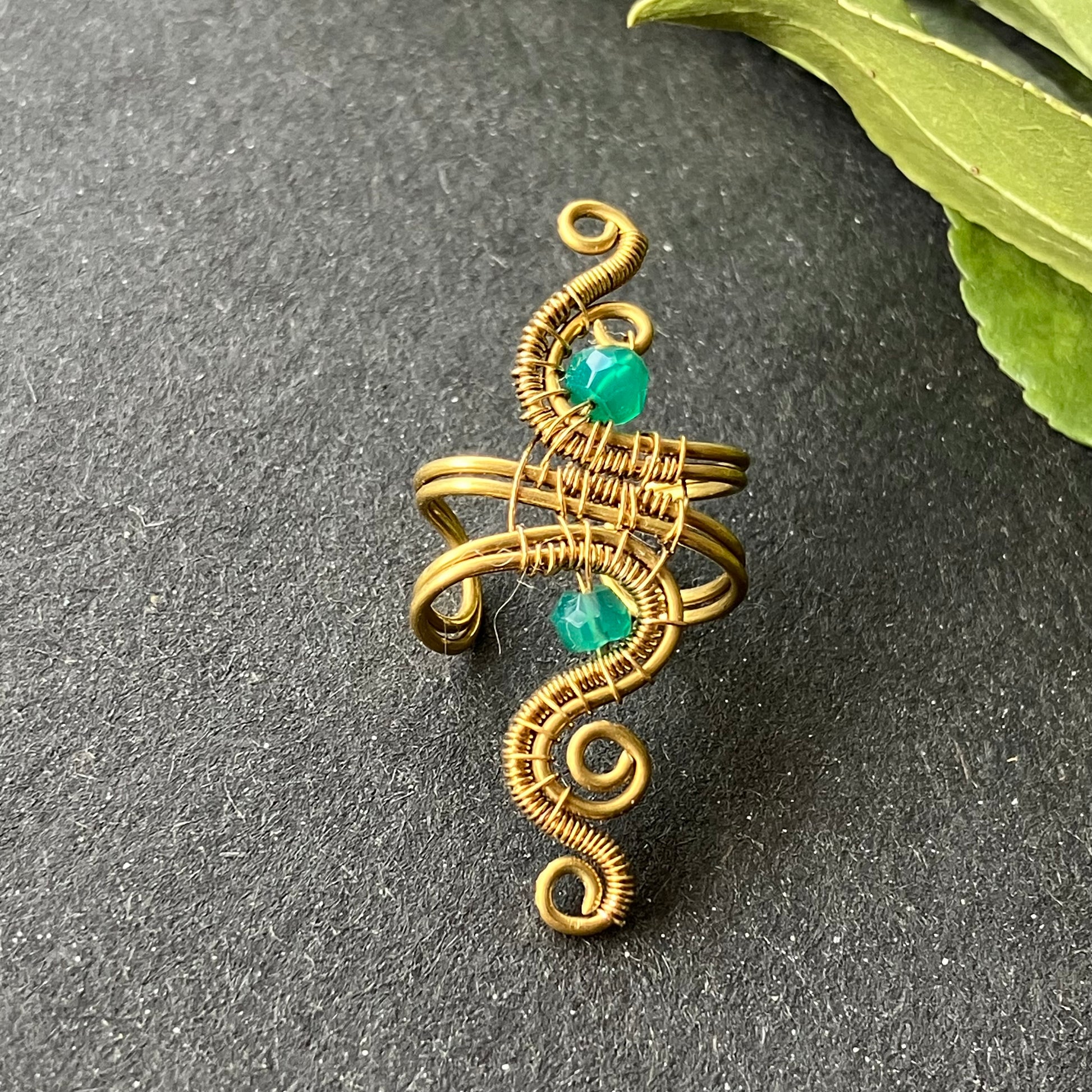 brass ear cuff adorned with green onyx stones