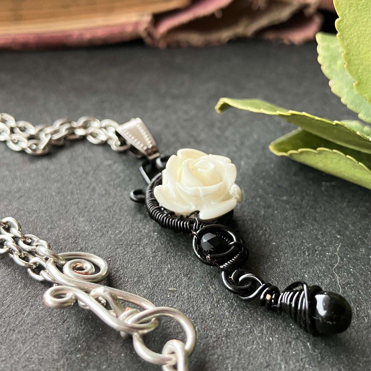 White rose and black necklace