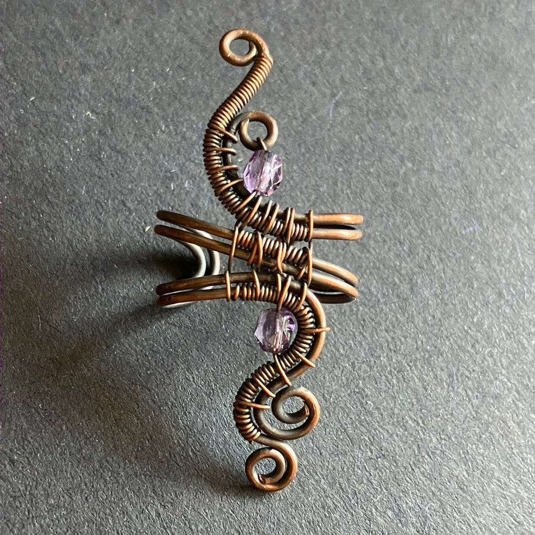 copper wire wrapped ear cuff with translucent pale purple beads 