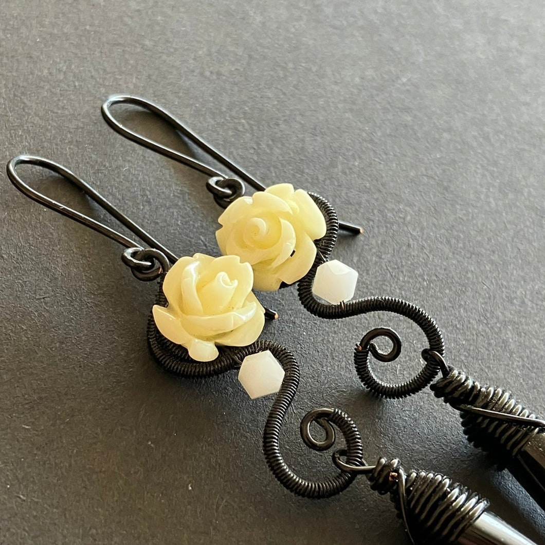 black wire wrapped dangle earrings with off-white rose beads