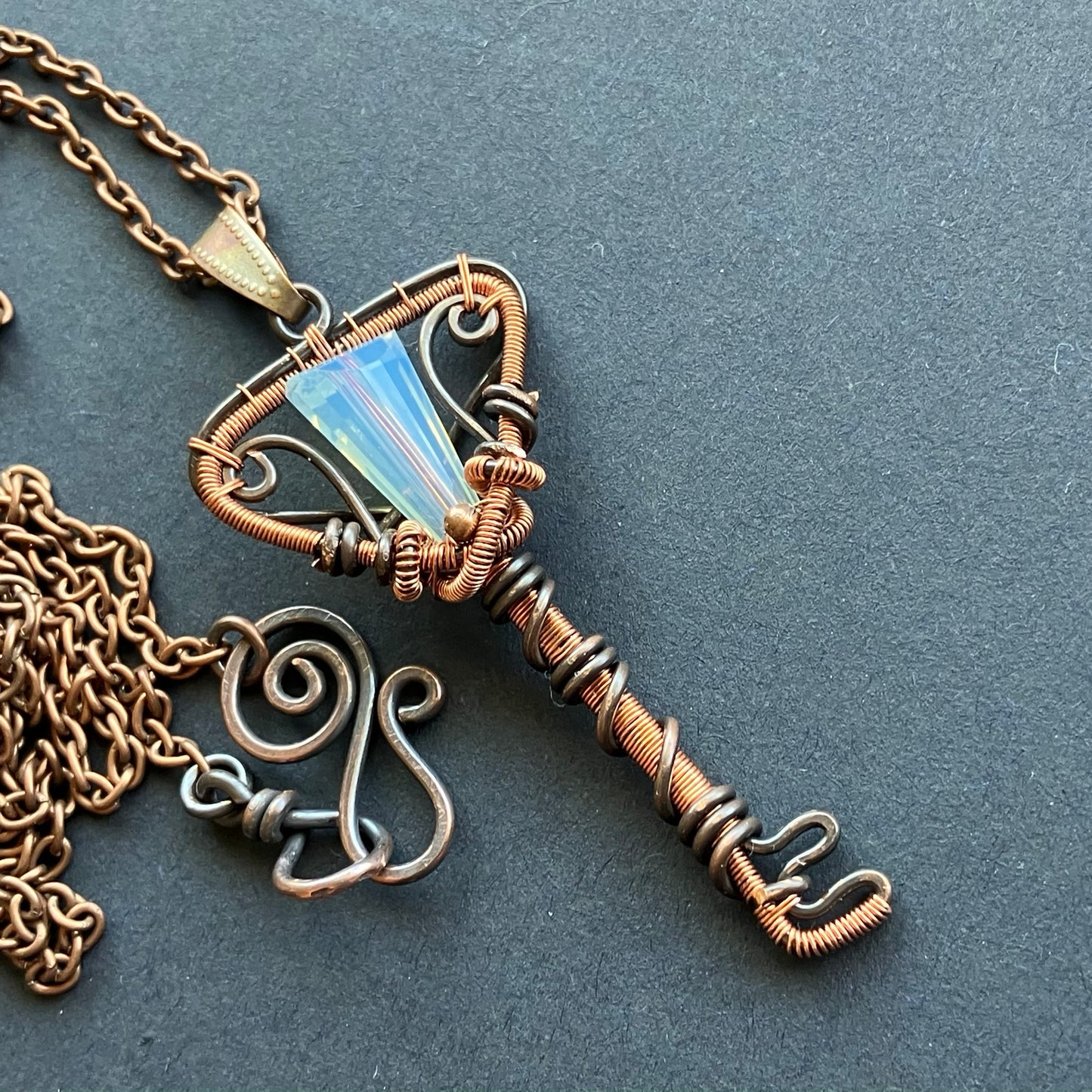 copper key pendant necklace with opalescent bead