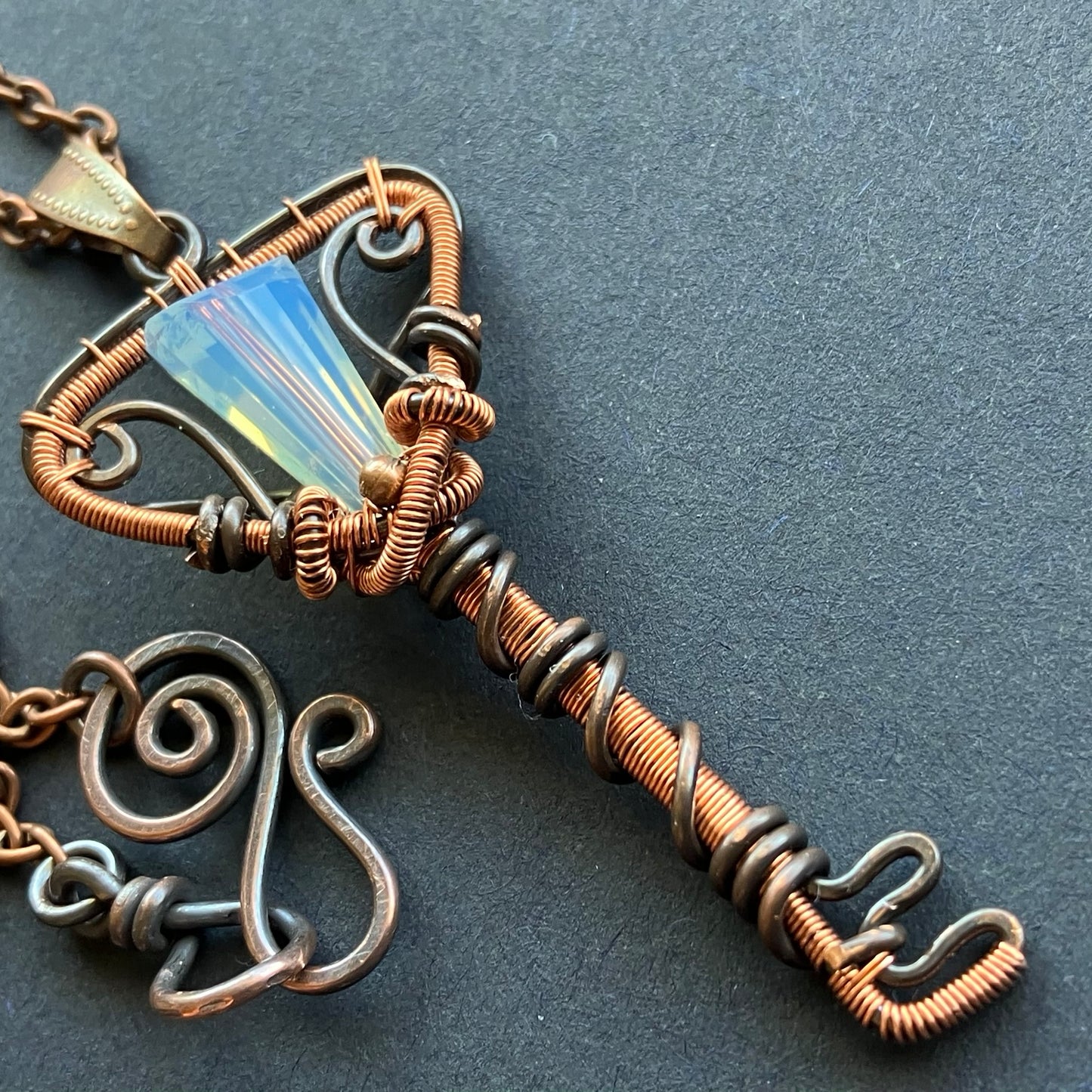 copper key pendant necklace with opalescent bead