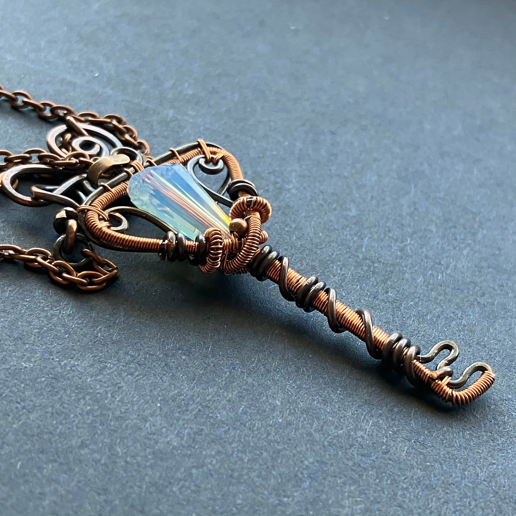 copper key pendant necklace with opalescent bead