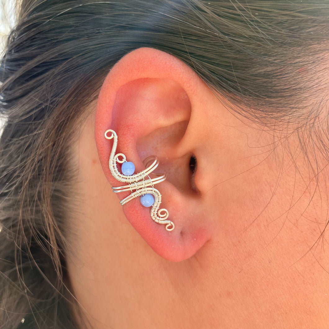 wire wrapped silver ear cuff with light blue beads