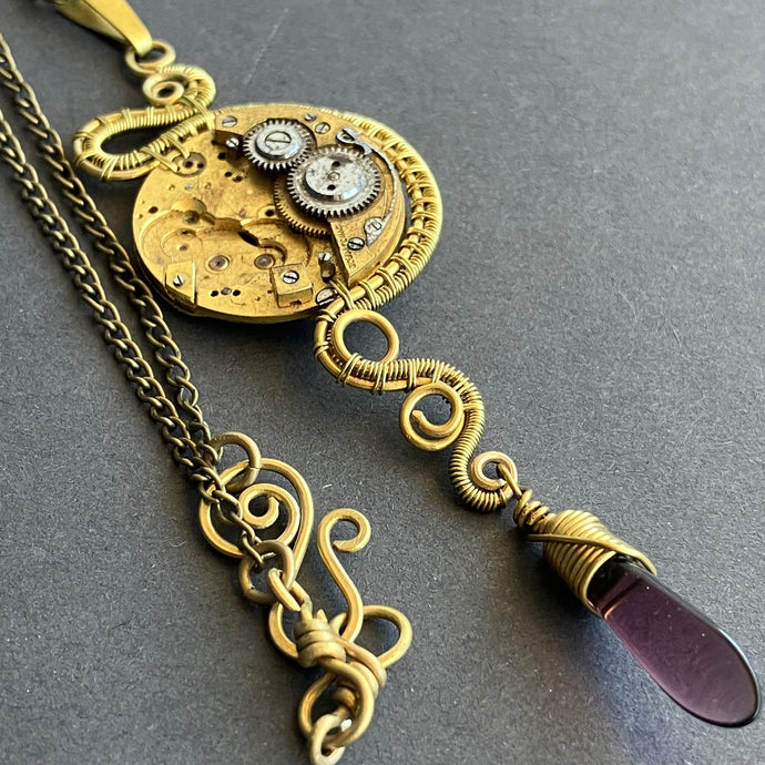 steampunk brass clockwork with translucent purple bead