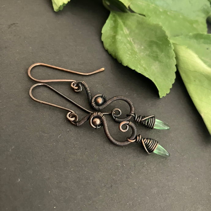 Oxidized copper earrings with green beads.