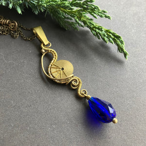 wire wrapped steampunk pendant with blue glass bead