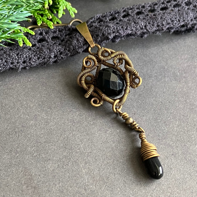 brass wire wrapped pendant with black glass bead on black lace choker 