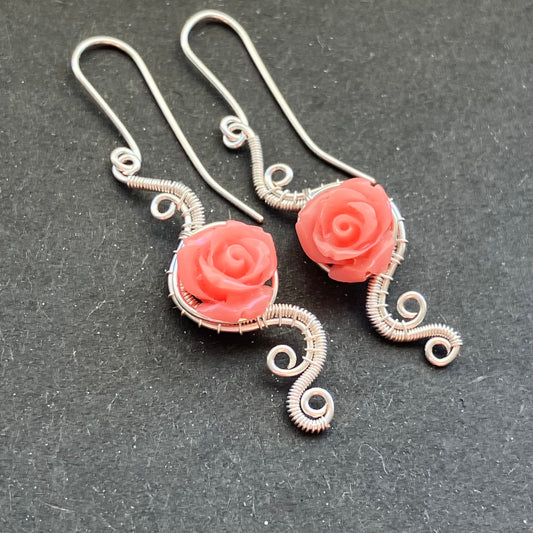 A pair of silver-plated pink earrings with a rose design 