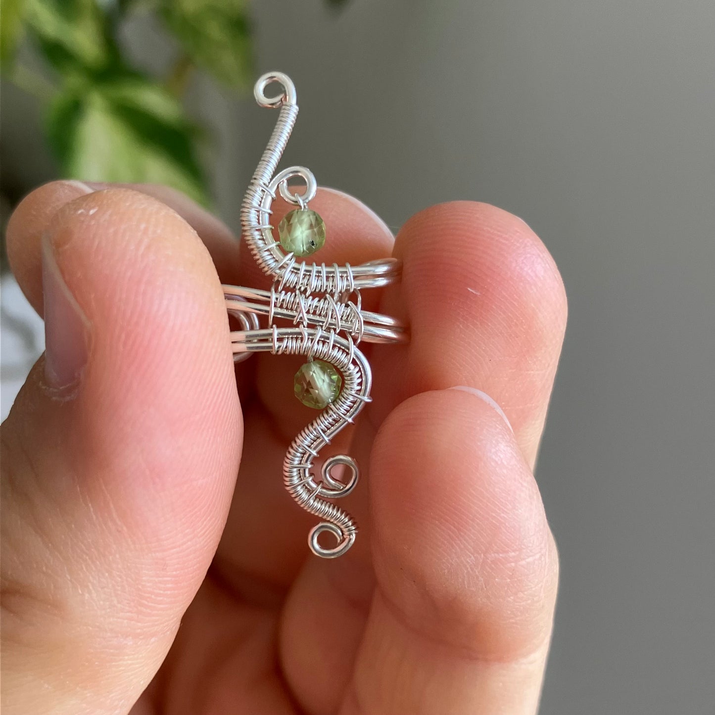 wire-wrapped ear cuff with a green gemstone 