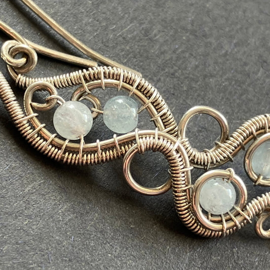 sterling silver earrings with wire wrapping and aquamarine beads.