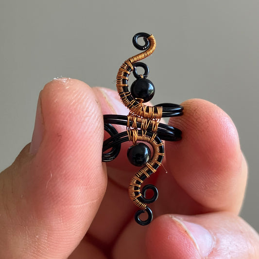 wire-wrapped black and copper ear cuff with onyx
