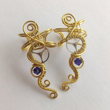 Load image into Gallery viewer, wire wrapped brass ear cuff with a silver gear and a purple swarovski bead
