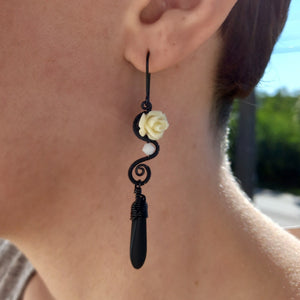 black wire wrapped dangle earrings with off-white rose beads