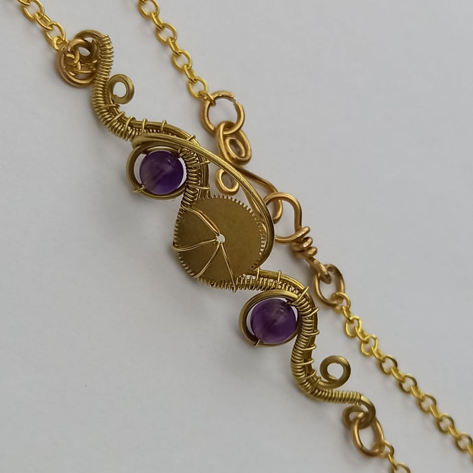 steampunk brass neclace with wire wrapped pendant and amethyat beads