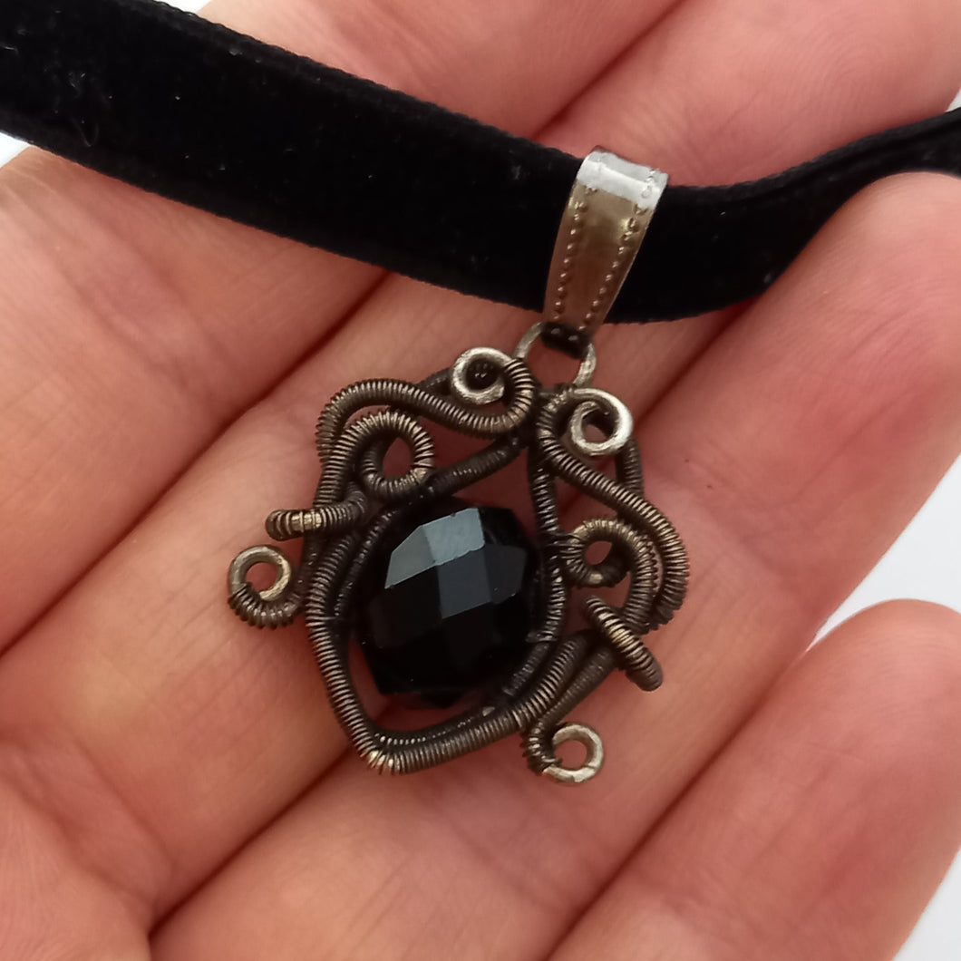 silver color wire wrapped pendant with faceted black glass bead on black velvet choker