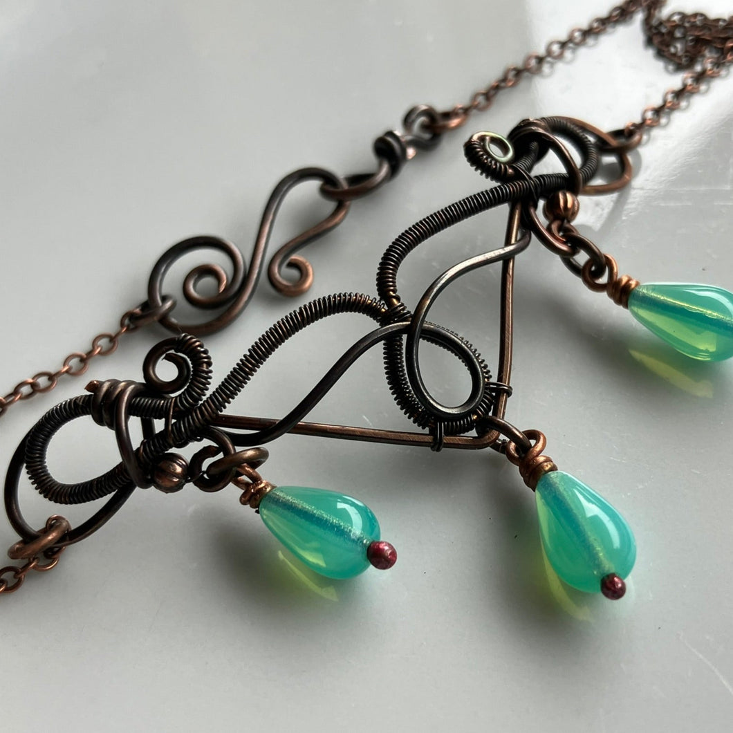 wire wrapped copper necklace with wide pendant and turquoise beads