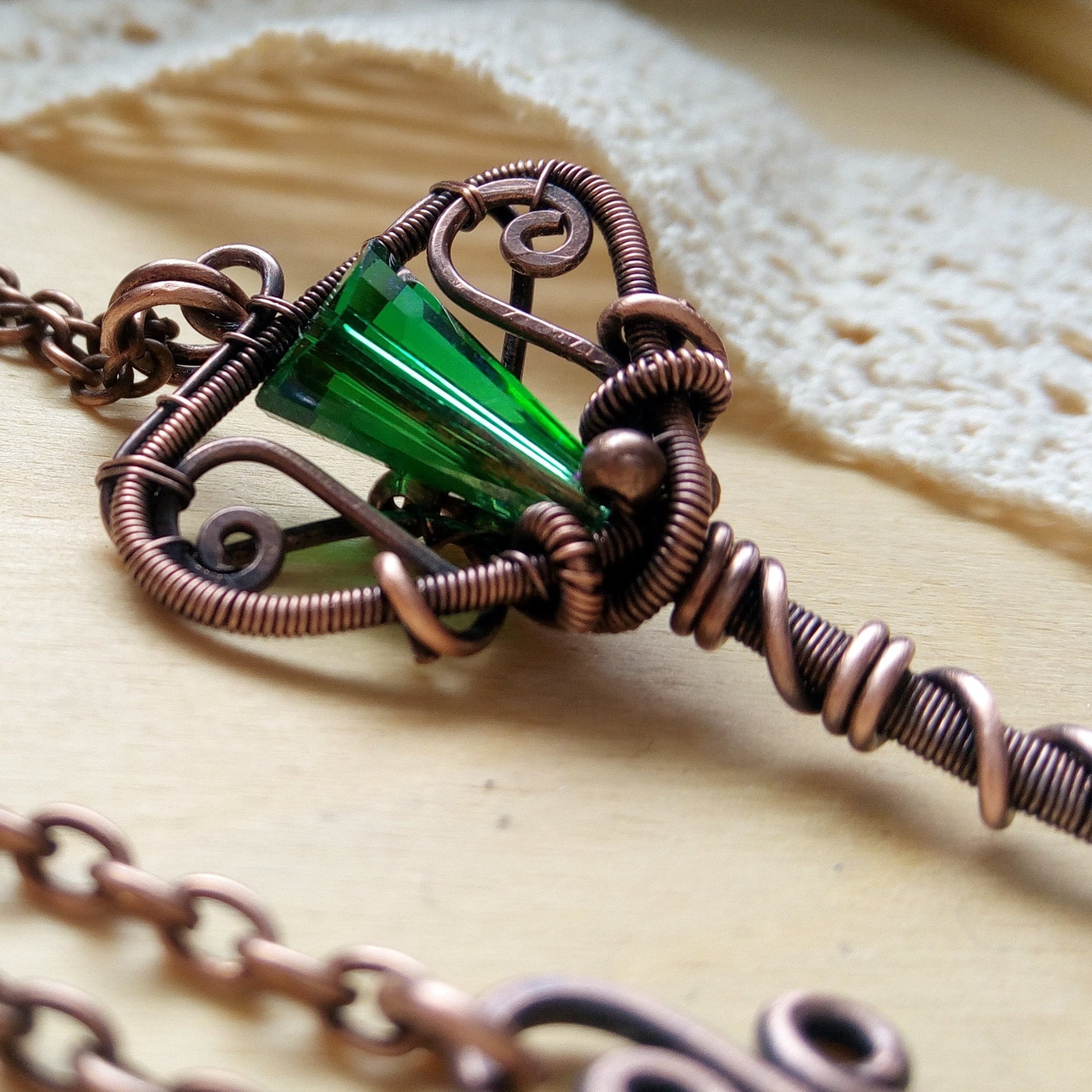 wire wrapped copper necklace with key shaped pendant and green bead