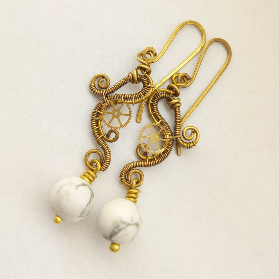 brass wire wrapped dangle earrings with gears and howlite beads