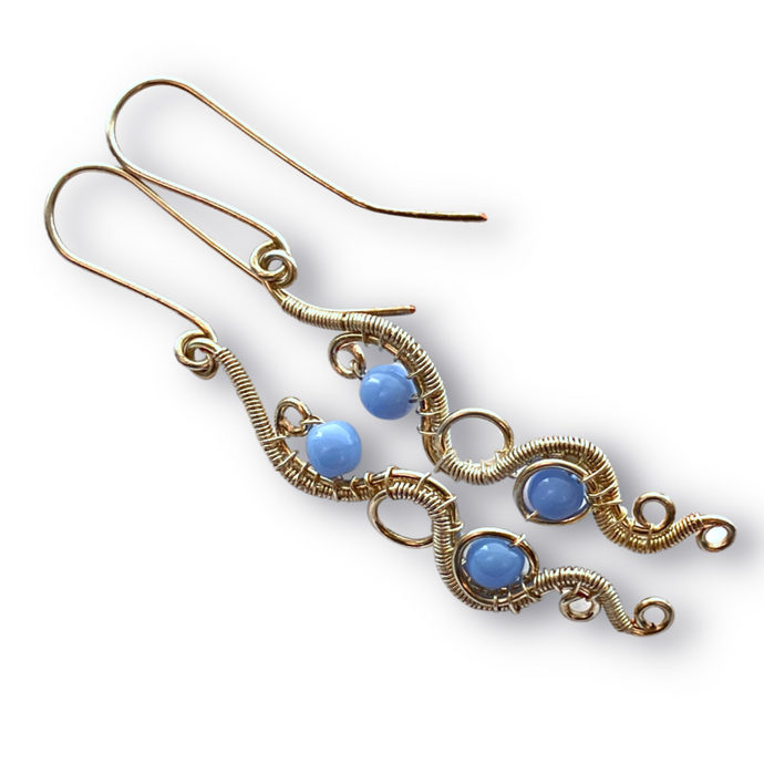 wire wrapped silver dangle earring with light blue beads